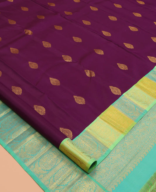 Purple Kanchipuram Silk Saree, Decked Up with Zari Buttas, a Contrast Korvai Manga Border, Intricate Pallu, and a Contrast Blouse