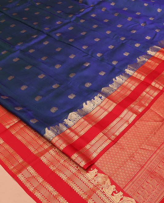 Blue Vasundhara Silk Saree, Dazzled with Mayil and Yaanai Buttas All Over Its Body, Complemented by Contrast Border of Wedding-Theme Motifs, Ara Bogudi, Muthu, and Ara Maadam Designs, Grand Jaal Pallu, and Paired with a Contrast Blouse