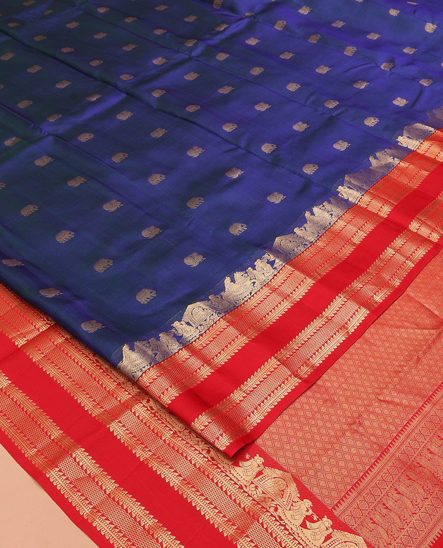 Blue Vasundhara Silk Saree, Dazzled with Mayil and Yaanai Buttas All Over Its Body, Complemented by Contrast Border of Wedding-Theme Motifs, Ara Bogudi, Muthu, and Ara Maadam Designs, Grand Jaal Pallu, and Paired with a Contrast Blouse