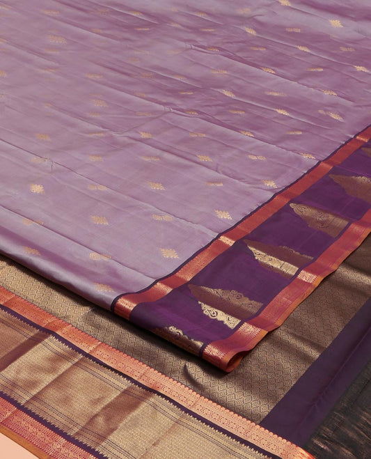 Lavender Vasundhara Lite Silk Mix Saree, Spotlighted with Zari Buttas on Its Body, Complemented by a Contrast Border of Thilakam Mokku, Mayil, and Yaali Designs, a Grandly Zari Decked Up Pallu, and Paired with a Contrast Blouse