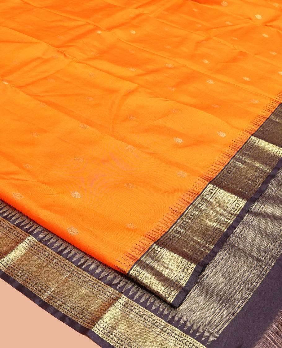 Orange Vasundhara Silk Saree, Artfully Woven with Mayil Buttas All Over Its Body, Complemented by Contrast Border Featuring Thazampoo Rekku, Muthu, Lavangam, and Mayil Kann Designs, a Grand Pallu of Jaal Designs, and Paired with a Contrast Blouse