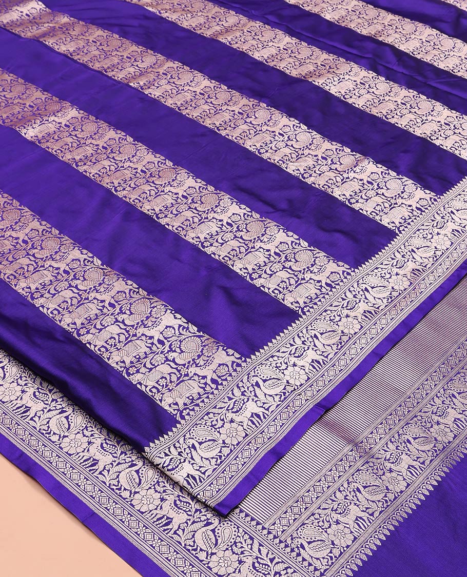 Blue Mushuru Silk Saree, Elegantly Decked Up with Vertically Woven Flora-Fauna Zari Designs On Its Body, Highlighted by Zari Border of Peacock and Deer Motifs, Grand Pallu, and Paired with a Plain Blouse