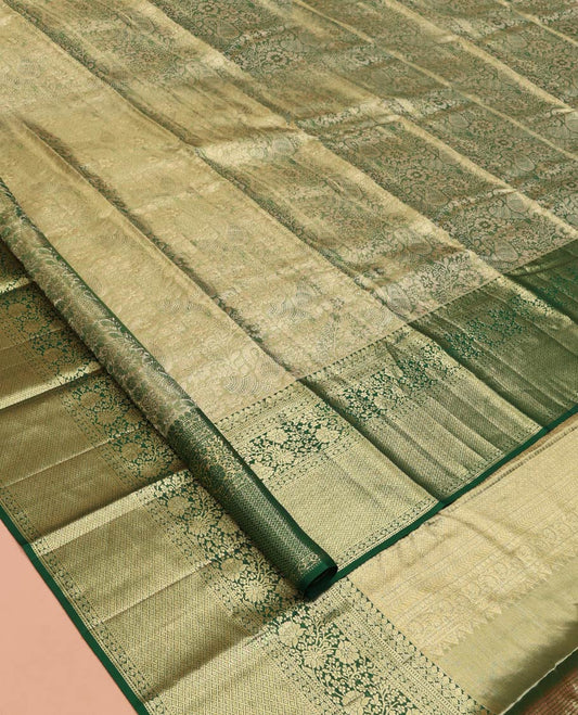 Green Kanchipuram Tissue Silk Saree, Majestically Detailed with Jacquard Designs on Its Body, Highlighted by a Zari Border of Jaal, and Floral Designs, Intricately Designed Pallu, and Paired with a Matching Blouse