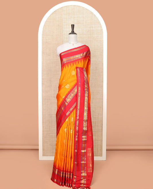 Orange Gadwal Saree Zari Accentuated with Chakra Buttas, Contrast Temple Border of Traditional Zari Designs, Pallu of Zari Designs, and a Contrast Blouse Complemented with Zari Designs