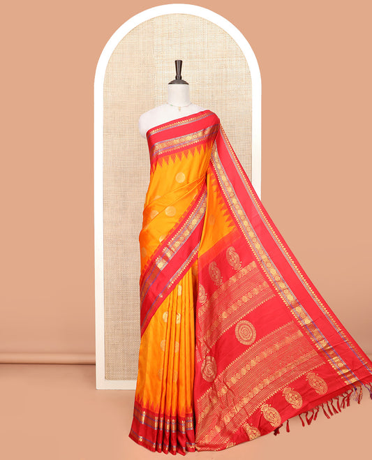 Orange Gadwal Saree Zari Accentuated with Chakra Buttas, Contrast Temple Border of Traditional Zari Designs, Pallu of Zari Designs, and a Contrast Blouse Complemented with Zari Designs