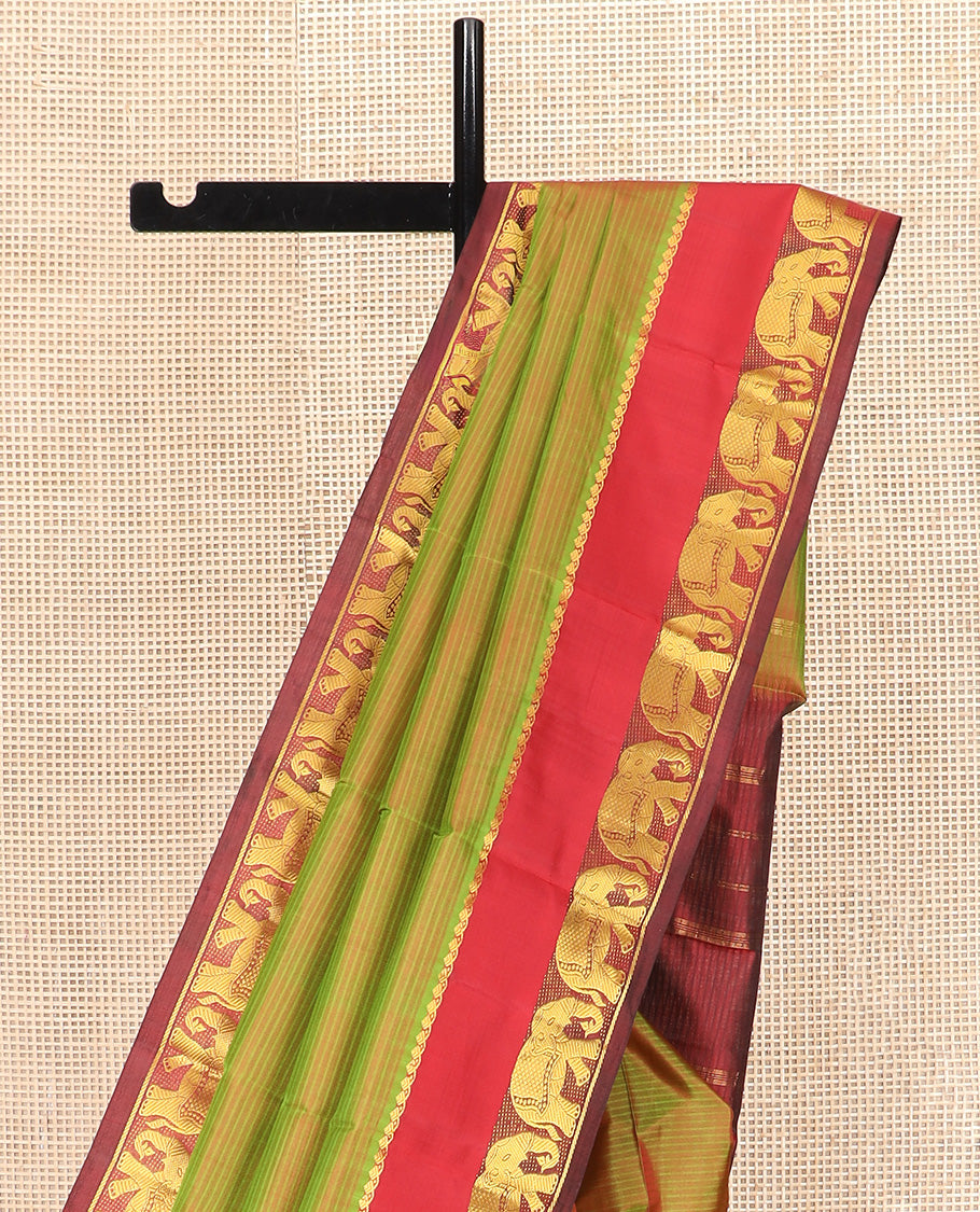 Green Dual-Toned Vazhaipoo Striped Kanchipuram Silk Saree, Complemented by Contrast Rettai Pettu Border of Thilakam Mokku, and Yaanai Designs, Pallu Subtly Woven in Stripes, and Paired with a Contrast Blouse