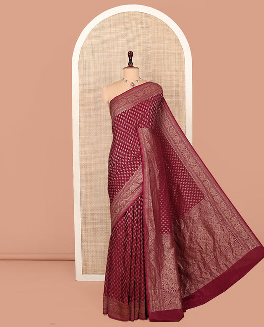 Light Maroon Fancy Crepe Saree, Steeped with Buttas, Highlighted by a Floral Creeper Border, Intricately Designed Pallu, and a Matching Blouse