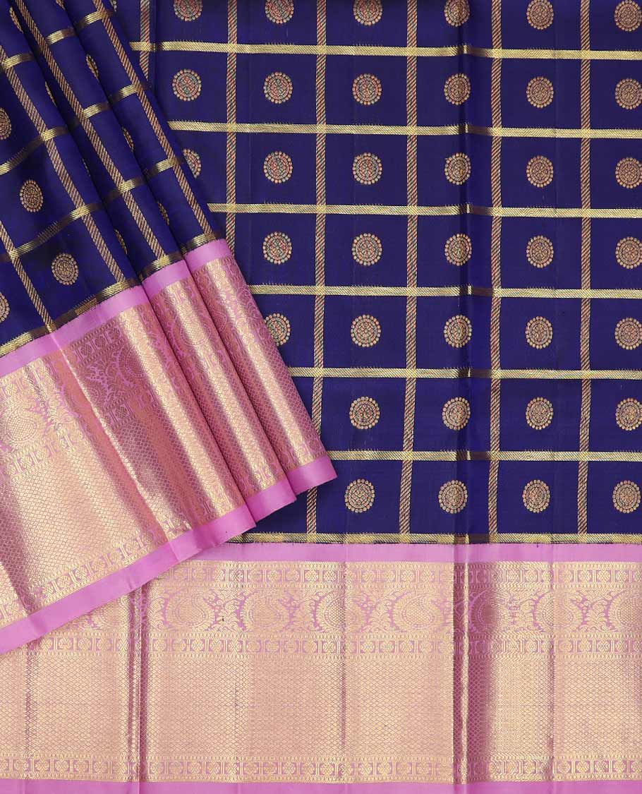 Blue pure silk half saree, chakram enclosed checked skirt, contrast zari design blouse, border of rudraksham, manga and mayil kann designs, and intricate dhavani