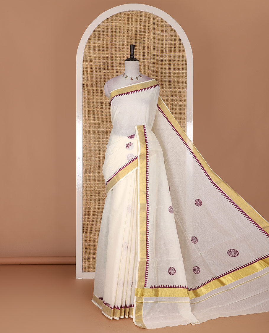 Half-white and maroon chakram motifs printed Kerala cotton saree, temple gold zari border, gold zari pallu, and matching blouse