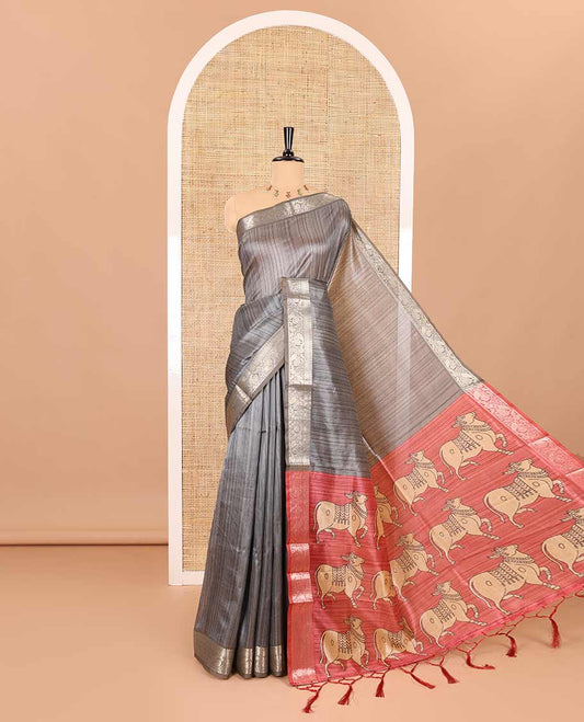 Grey striped semi-tussar saree, traditional zari border of floral creeper designs, contrast pallu of Pichwai cow print, and contrast Pichwai cow printed blouse