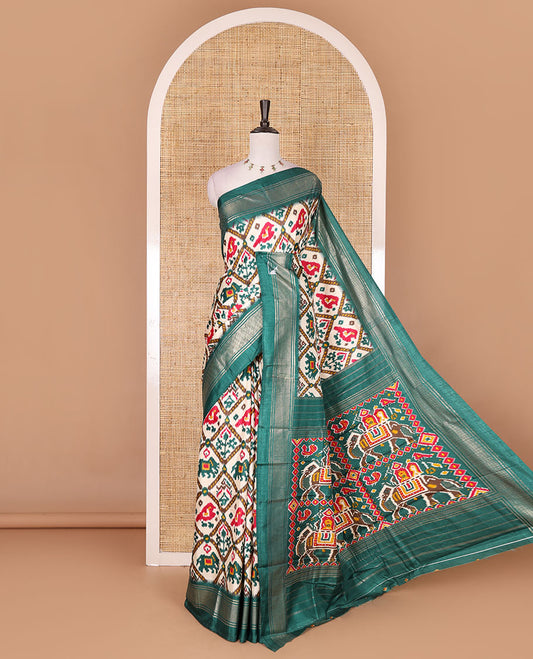 Half-white and green buttas enclosed jaal patterned patola-inspired pochampally dola silk saree, contrast green zari border, patola elephant pallu, and contrast blouse