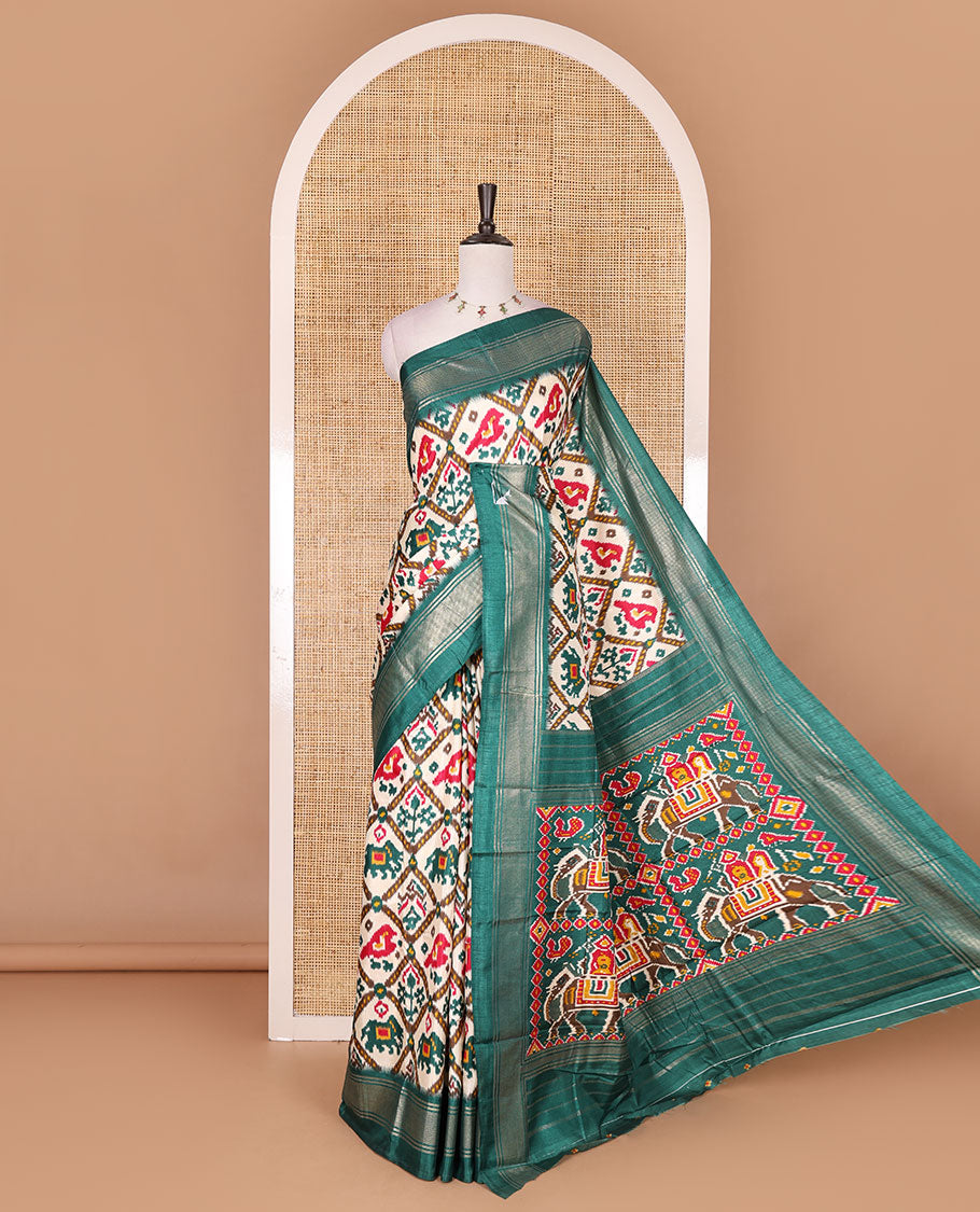 Half-white and green buttas enclosed jaal patterned patola-inspired pochampally dola silk saree, contrast green zari border, patola elephant pallu, and contrast blouse