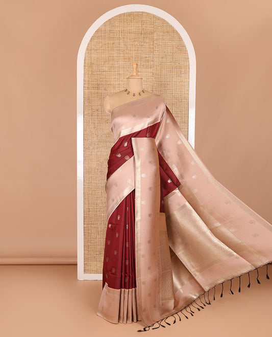 Maroon zari buttas soft silk saree, contrast zari border of intricate designs, zari-rich jaal pallu, and a contrast zari design blouse
