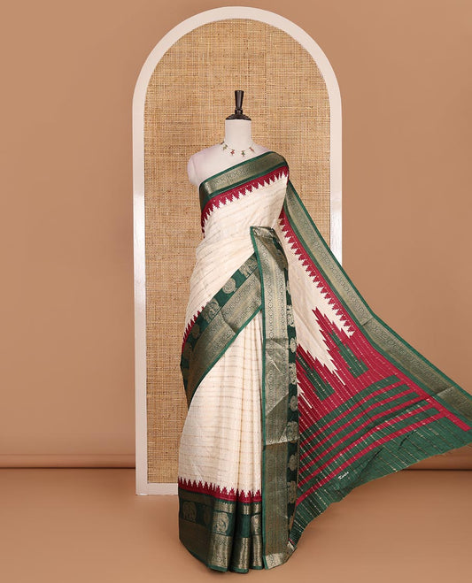 Half-white zari designs dola silk saree, contrast green temple traditional border of peacock and elephant motifs, and temple pallu