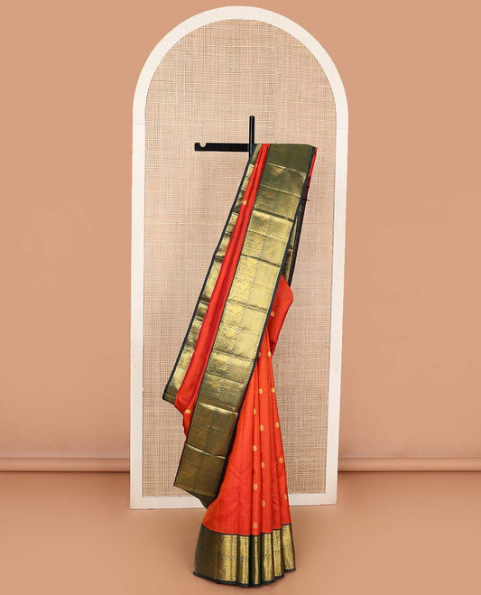 Orange chakram buttas Kanchipuram korvai silk saree, contrast neer korvai border of rekku, muthu, mayil, chakram, poun, and kuyil kann designs, and jaal pallu