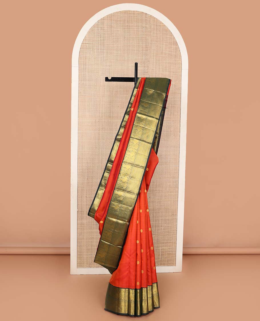 Orange chakram buttas Kanchipuram korvai silk saree, contrast neer korvai border of rekku, muthu, mayil, chakram, poun, and kuyil kann designs, and jaal pallu