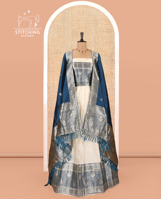 Cream-Peacock Blue Semi-Banarasi Half-Saree Set Featuring Buttas Skirt, Contrast Traditional Border, a Matching Blouse, and a Banaras Dhavani