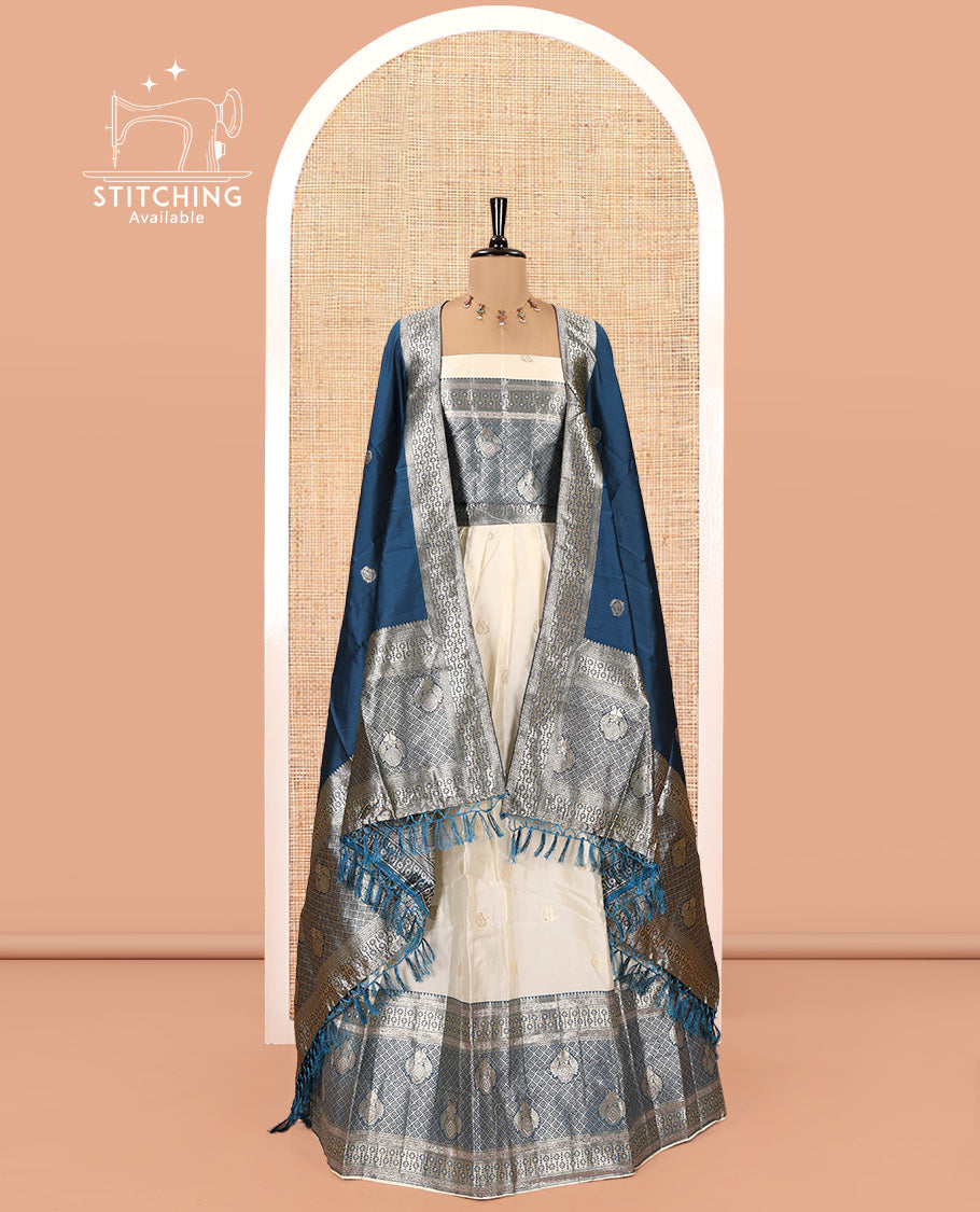 Cream-Peacock Blue Semi-Banarasi Half-Saree Set Featuring Buttas Skirt, Contrast Traditional Border, a Matching Blouse, and a Banaras Dhavani
