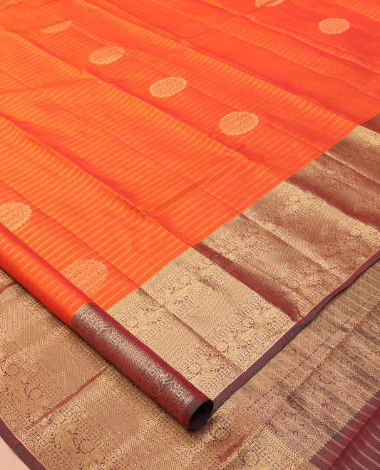 Orange Vasundhara Lite Silk Mix Saree, Bedecked with Zari Buttas and Stripes, a Contrast Border of Kodi Visiry, Mayil, and Mayil Kann Designs, Jaal Pallu, and a Contrast Blouse
