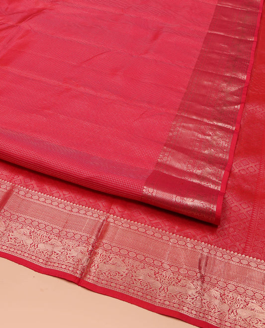 Red Vasundhara Silk Saree, Subtly Sparkled with Zari Checks All Over Its Body, Highlighted by Zari Border of Thilakam Mokku, Kamalam, Mayil Kann, Rudraksham, and Kuthirai Designs, Pallu of Jaal Designs, and Paired with a Matching Blouse