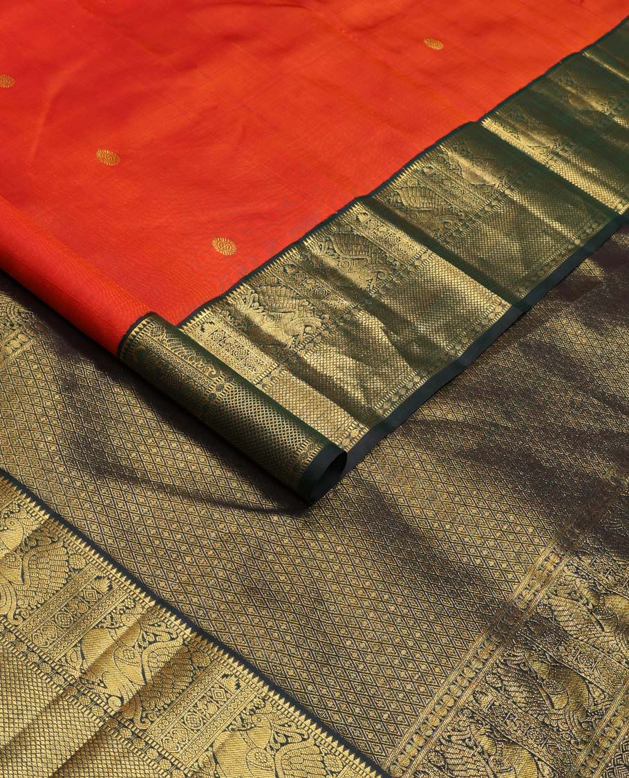 Orange chakram buttas Kanchipuram korvai silk saree, contrast neer korvai border of rekku, muthu, mayil, chakram, poun, and kuyil kann designs, and jaal pallu