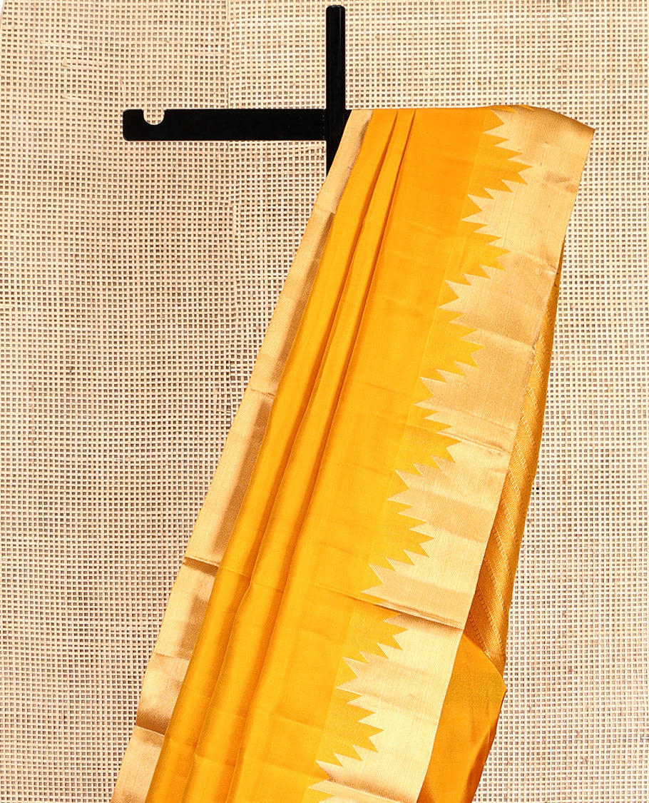 Yellow Plain Kanchipuram Silk Saree, Highlighted by a Zari Thazampoo Rekku Border, Diagonally Striped Pallu, and a Matching Blouse