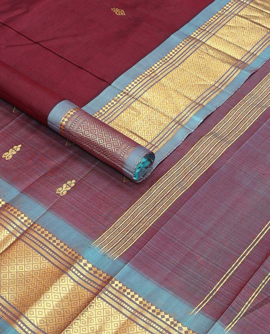 Maroon  buttas kancheepuram silk saree with contrast border of rekku, thilakam mokku, banaras design & zari design pallu