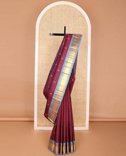 Maroon  buttas kancheepuram silk saree with contrast border of rekku, thilakam mokku, banaras design & zari design pallu