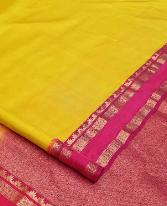 Lemon yellow plain Kanchipuram silk saree, contrast rettai pettu border of thazampoo rekku, neli, poo chakram, and kuthirai designs, and jaal pallu