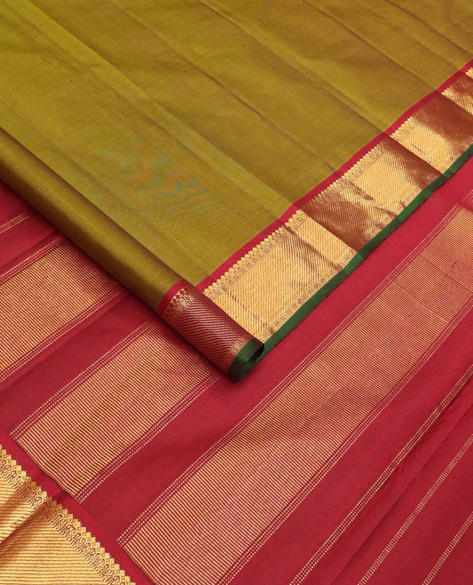 Green plain Kanchipuram silk saree, contrast border of thilakam mokku, muthu, cross kamalam, and zari stripes, and zari woven pallu