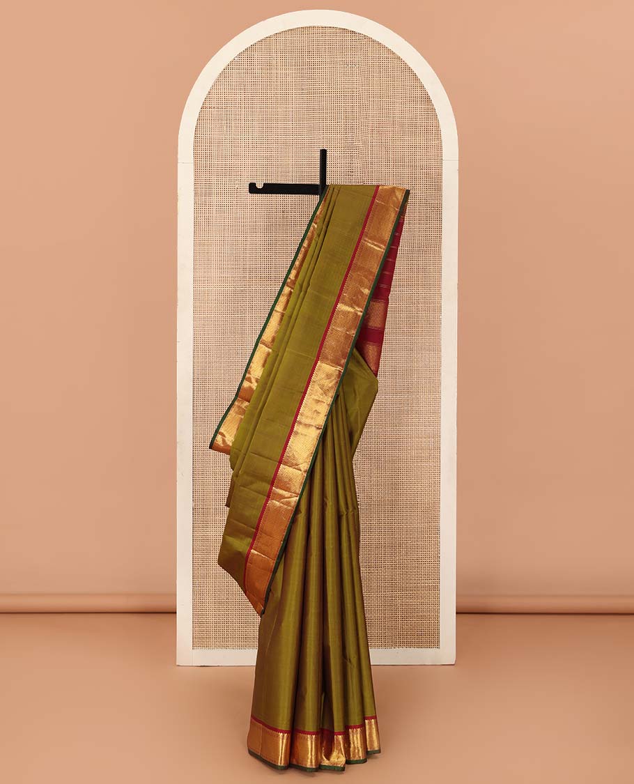 Green plain Kanchipuram silk saree, contrast border of thilakam mokku, muthu, cross kamalam, and zari stripes, and zari woven pallu