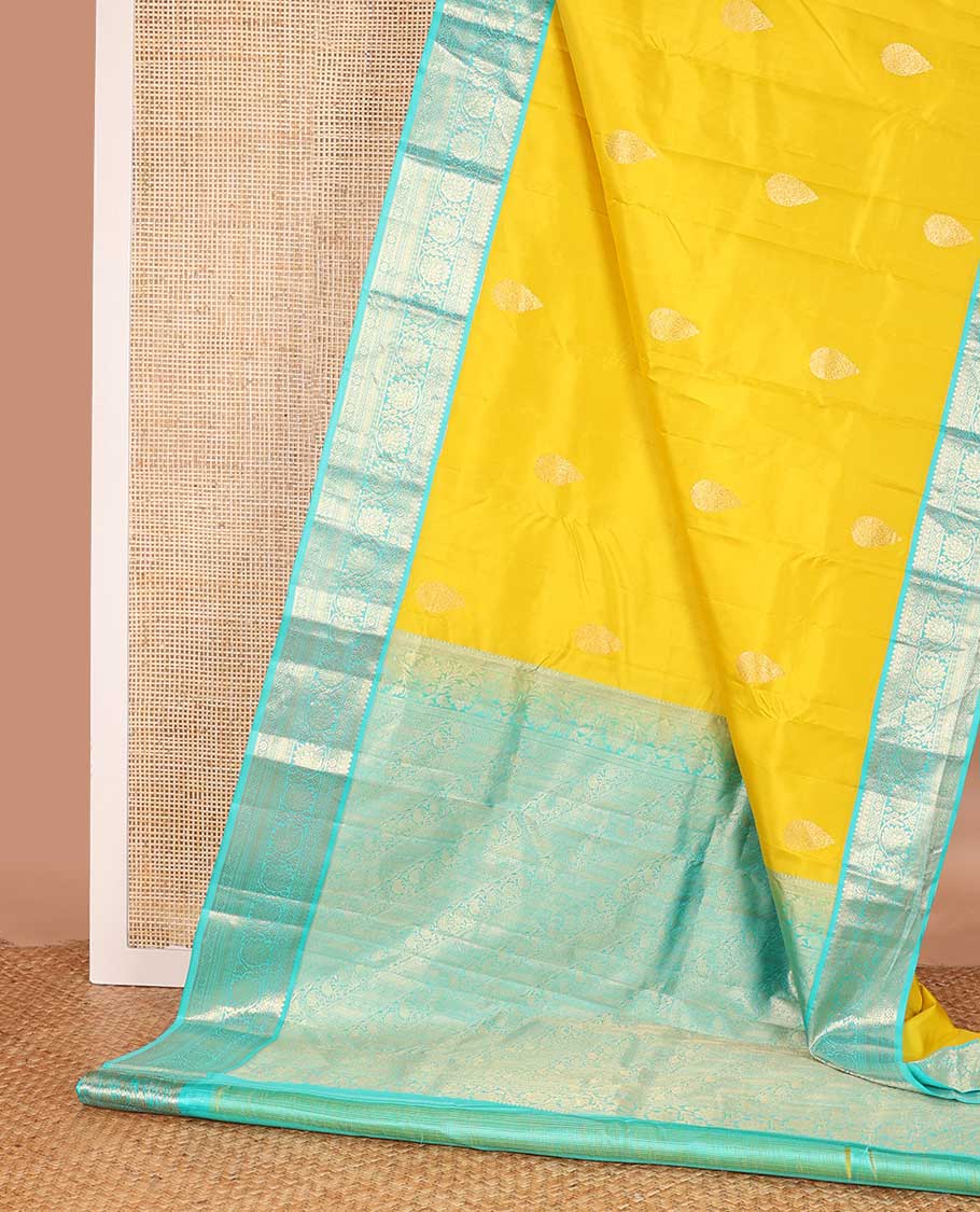 Yellow zari buttas silk saree, contrast border of jadai nagam, and mayil kann, and pallu of diagonally woven kodi manga and geometric designs