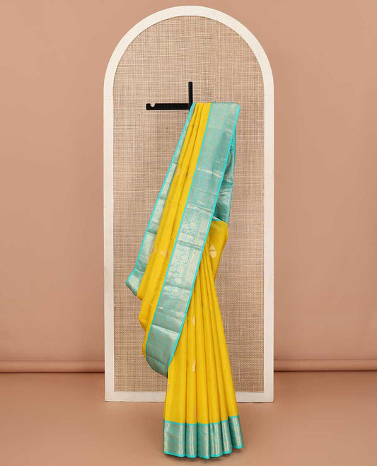 Yellow zari buttas silk saree, contrast border of jadai nagam, and mayil kann, and pallu of diagonally woven kodi manga and geometric designs