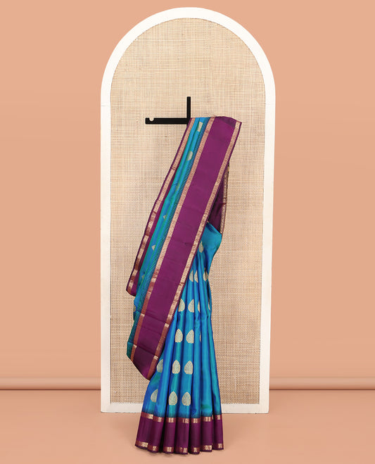 Blue Vasundhara Silk Saree, Delicately Woven with Zari Buttas All Over Its Body, Complemented by a Contrast Rettai Pettu Temple Border of Banaras, and Manga Designs, Grand Jaal Pallu, and Paired with a Contrast Blouse