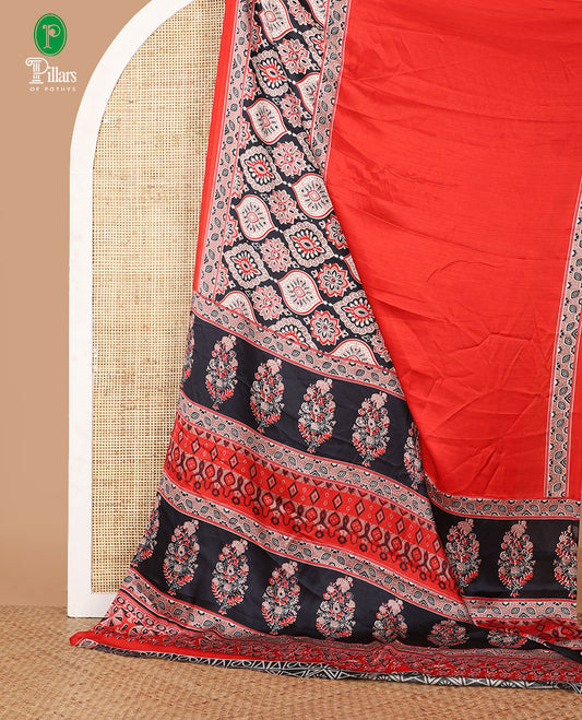 Red half-&-half style modal satin saree features floral & geometric design Ajrakh printed contrast border & pallu