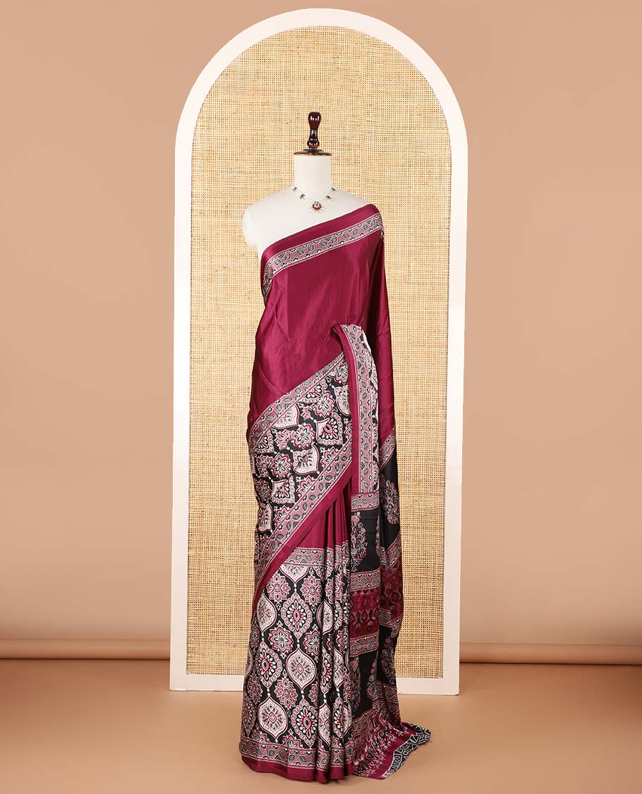 Wine color half-&-half style modal satin saree features floral & geometric design Ajrakh printed contrast border & pallu