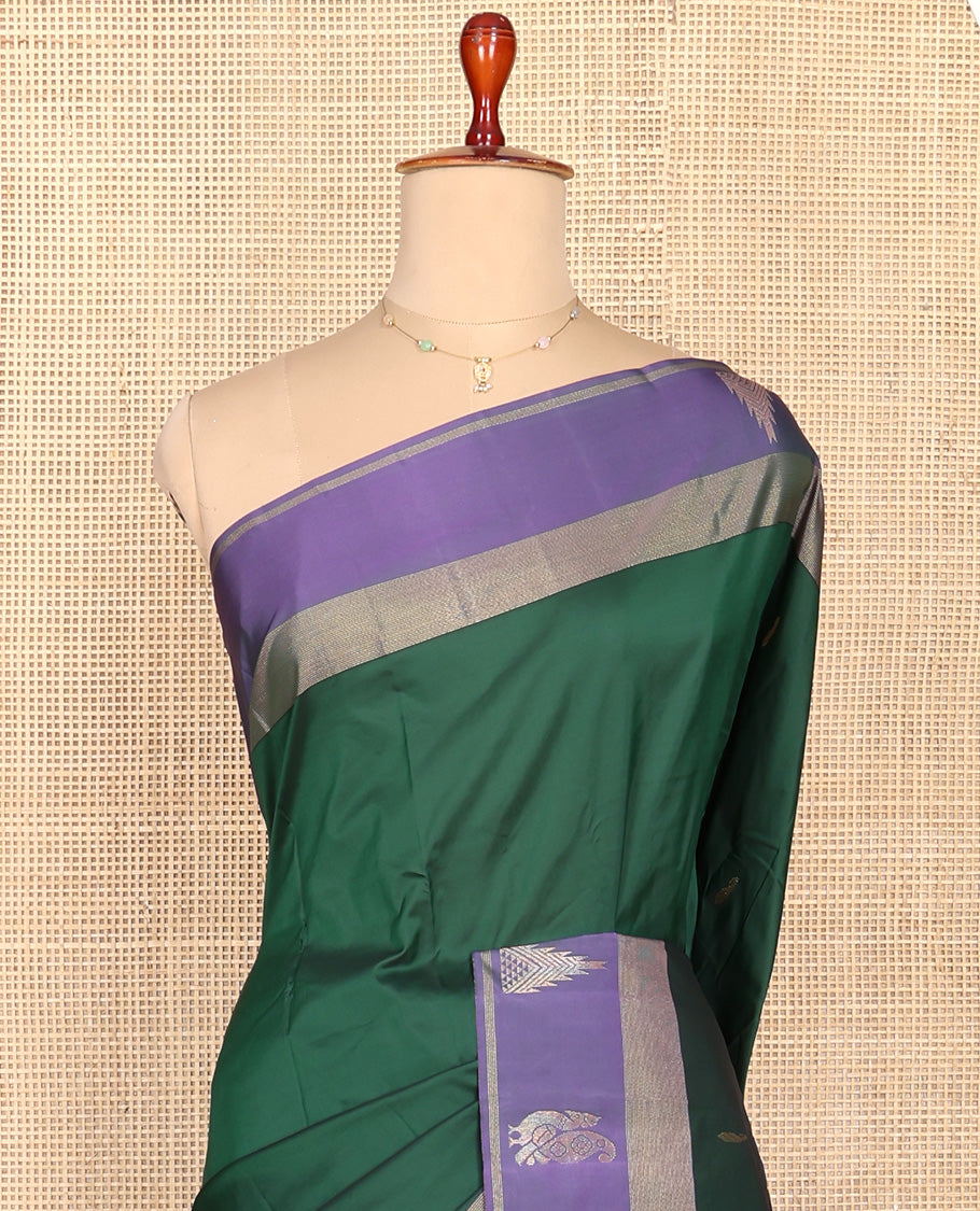 Green Aarani Silk Saree, Adorned with Zari Buttas All Over Its Body, Complemented by a Contrast Border of Peacock and Temple Border, Pallu of Zari Designs, and Paired with a Matching Blouse