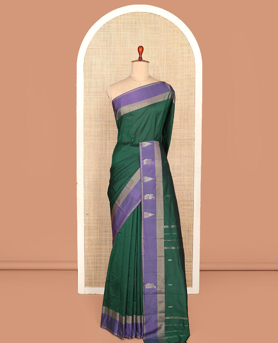 Green Aarani Silk Saree, Adorned with Zari Buttas All Over Its Body, Complemented by a Contrast Border of Peacock and Temple Border, Pallu of Zari Designs, and Paired with a Matching Blouse
