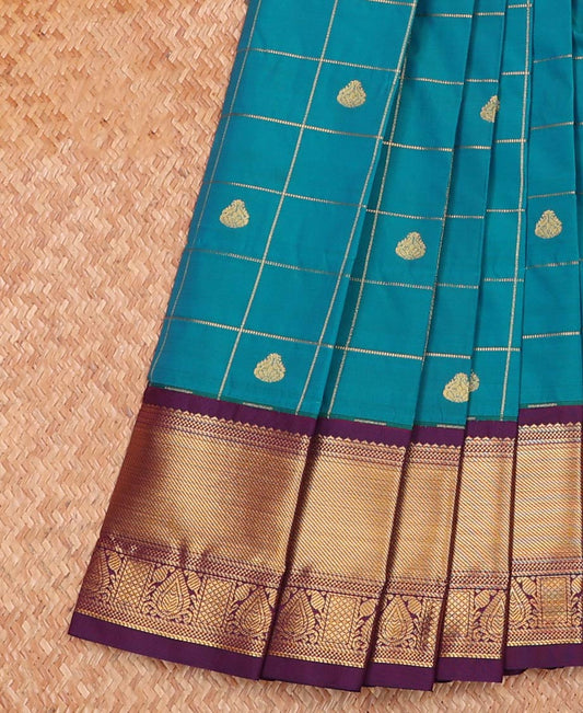 Blue Budget Silk Saree Accentuated with Zari Butta Enclosed Checks, Highlighted with Contrast Traditional Zari Design Border, Intricate Pallu, and a Paired with a Contrast Blouse