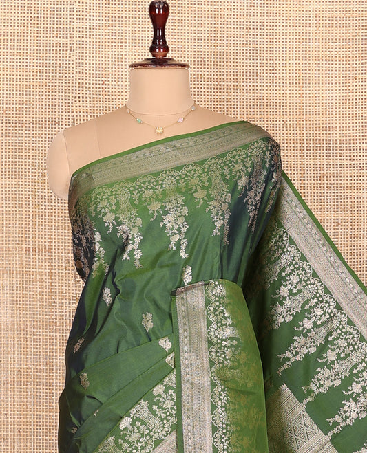 Green Budget Silk Saree, Richly Detailed with Floral Zari Buttas All Over Its Body, Highlighted by a Zari Border of Floral Designs, Grandly Woven Jaal Pallu, and Paired with a Matching Blouse