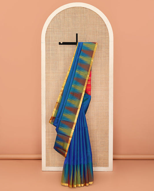 Blue plain Bangalore silk saree, contrast temple piping border, and zari-rich pallu of temple designs