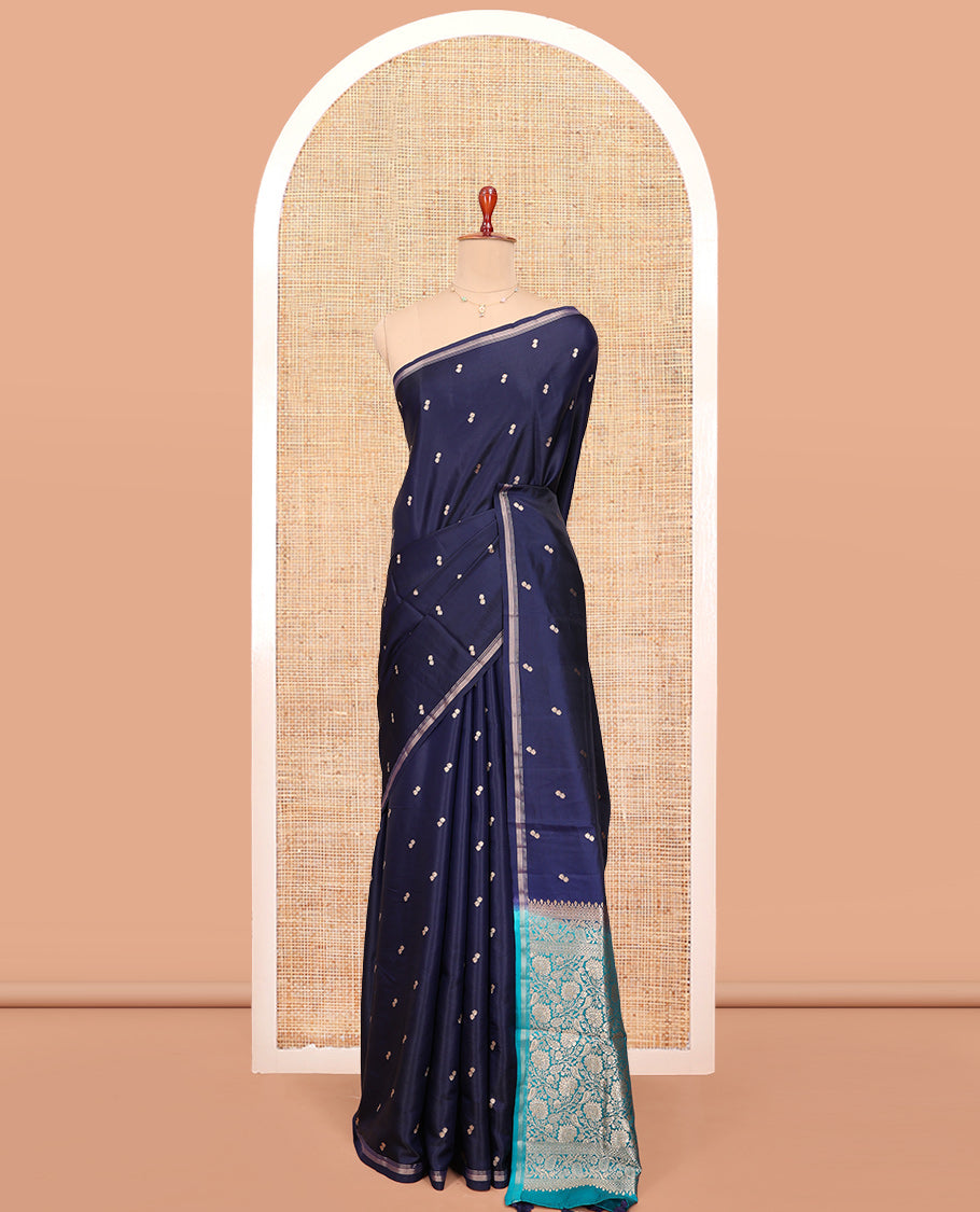 Navy Blue Satin Silk Saree, Delicately Woven with Buttas All Over Its Body, a Subtle Piping Border, Complemented by a Contrast Pallu of Floral-Paisley Designs in Zari, and Paired with a Contrast Blouse