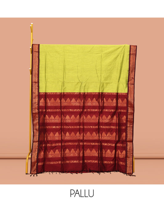 Light Green Plain Kalyani Cotton Saree, Complemented by a Contrast Traditional Zari Design Temple Border, Pallu Features Temple Zari Designs, and Paired with a Contrast Blouse