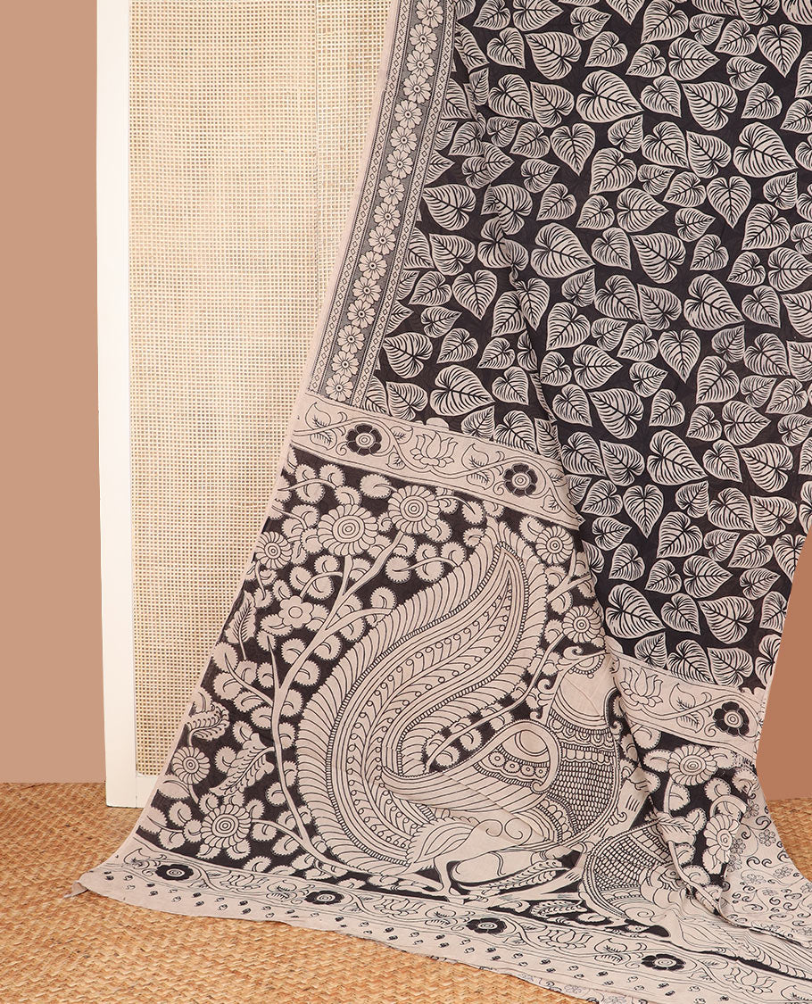 Black leaf motifs machine-printed kalamkari cotton saree, printed border, and pallu of floral vine and peacock print