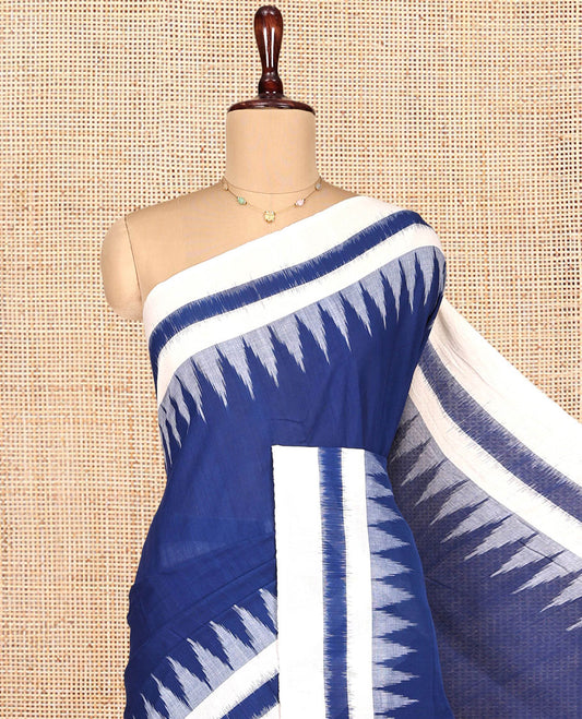 Navy Blue Plain Ikkat Cotton Saree, Complemented by a Contrast Ikkat Temple Border, Pallu Steeped with Buttas, and Paired with a Contrast Blouse