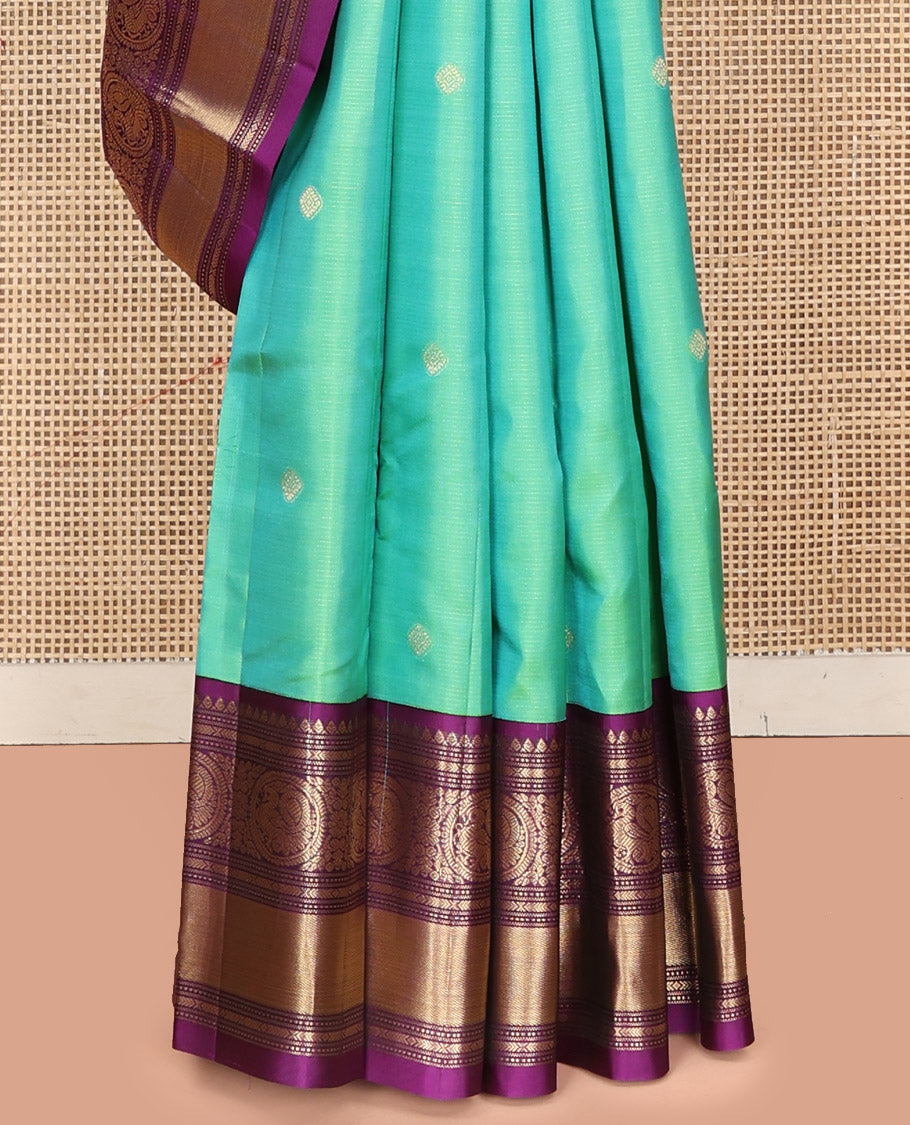 Rexona Green Vasundhara Silk Saree, Beautified with Sparse Stripes and Zari Buttas, Complemented by a Contrast Border of Thilakam, Banaras, Muthu, and Round Mayil Designs, Pallu Steeped with Traditional Designs, and Paired with a Contrast Blouse