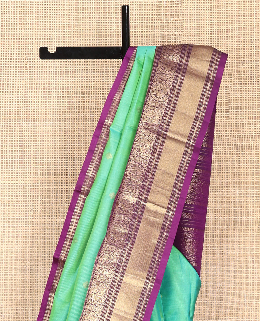 Rexona Green Vasundhara Silk Saree, Beautified with Sparse Stripes and Zari Buttas, Complemented by a Contrast Border of Thilakam, Banaras, Muthu, and Round Mayil Designs, Pallu Steeped with Traditional Designs, and Paired with a Contrast Blouse