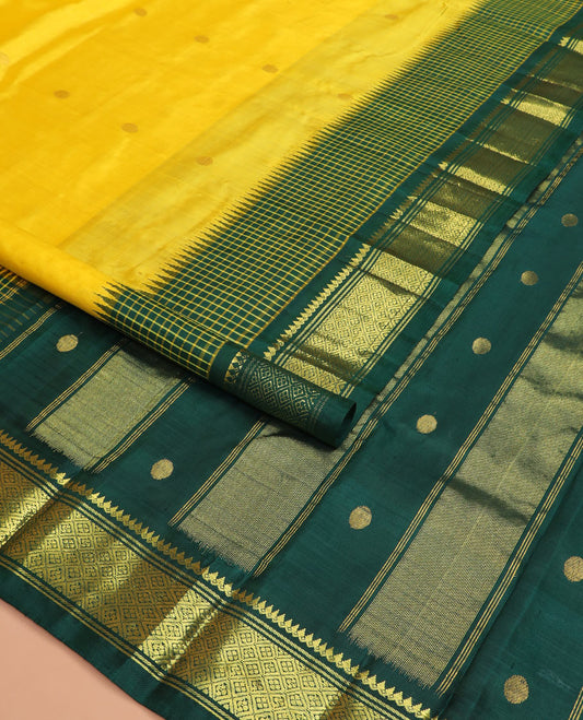 Yellow zari buttas Kanchipuram silk saree, contrast one-sided thazampoo rekku checked border of thilakam mokku, banaras, and jaal designs, and zari design pallu