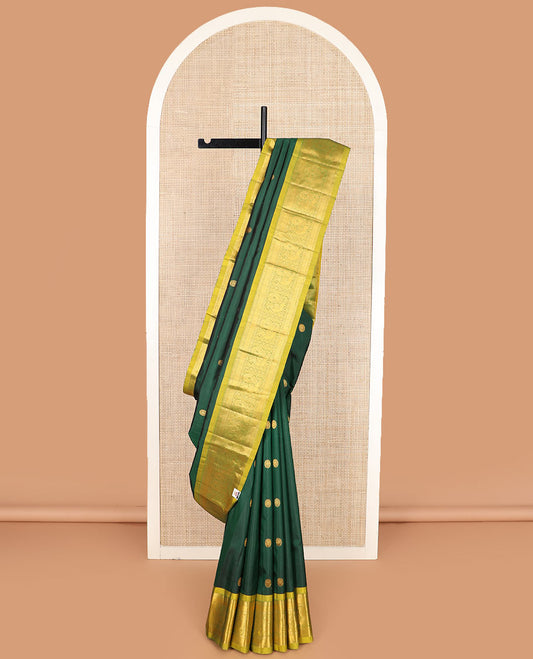 Green chakram zari buttas Kanchipuram silk saree, contrast border of rekku, muthu, mayil kann, and mayil designs, and mayil chakram motifs featured pallu