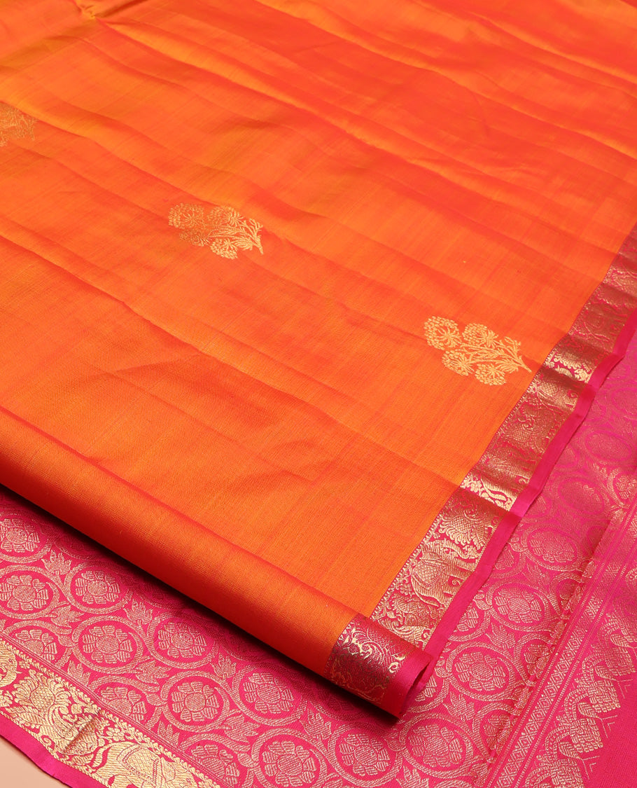Orange Kanchipuram Silk Saree, Accentuated with Zari Buttas All Over Its Body, Complemented by Contrast Border of Yaanai and Mayil Designs, Grand Floral Jaal Pallu, and Paired with a Contrast Blouse